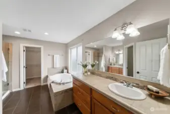 Spacious primary ensuite with double sinks, fully tiled walk-in shower & large soaking tub. Frosted glass adds nice privacy while still allowing the light to flow through.