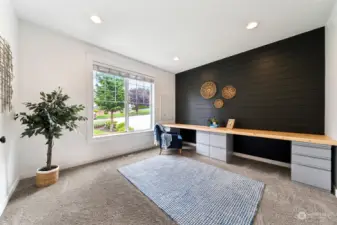 Just inside the foyer is the home office- built in desk, modern shiplap & large window is ready for you to start grinding those long hours working from home.