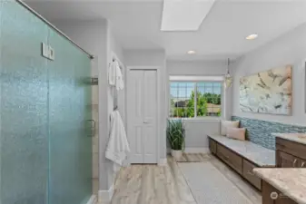 Spacious bathroom with tile walk in shower and plenty of storage.