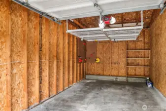 The garage offers extra overhead and tool storage.