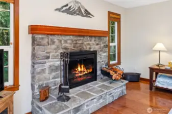 The wood fireplace has a custom wood mantel, designed by local Hoodsport artist Phil Day!