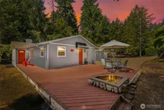 Faux twilight lighting shows the beauty of relaxing evenings on the deck at Lake Cushman.