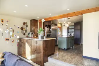 Quartz countertops with lots of workspace  Cupboards with glass fronts and undermount lights  Stainless lower cabinets with pull-out drawers   Built-in custom wine rack / Pantry / Appliance garage with shelves  Durable Luxury Vinyl Tile [LVT] floor