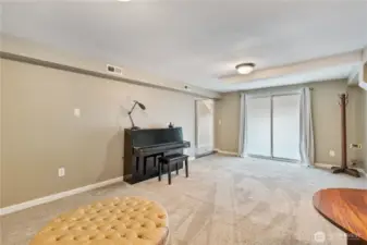 Family/rec room with lots of space. Sliding doors lead out to the covered carport.