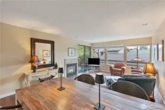 Good sized living room with a gas fireplace and a small deck off the front of this townhouse.