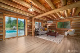 Slider that leads out to the wrap around porch and pool from living area