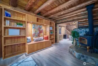 Built in bookcase and wood burning stove that connect the dining room and kitchen