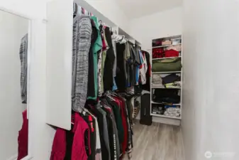 Primary walk in closet with organizers