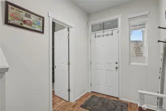 View of entrance and powder room. I love how the powder room is not right off the kitchen nor family room!
