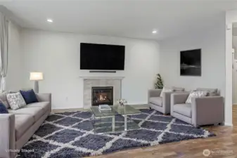 Down the hall, in the rear of the main floor you will find open-concept living with your family room and kitchen. Large family room with gas fireplace for cooler nights. ***Virtually Staged***