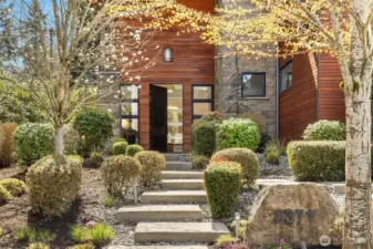 A welcoming approach framed by layered greenery and architectural detail.