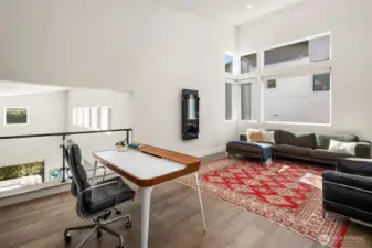 Upper-level flex space—ideal for media, lounge, or play—open to the architecture and filled with natural light.