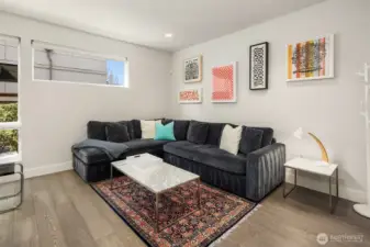 Lower-level lounge or media space—flexible, comfortable, and ideal for relaxed living or entertaining.