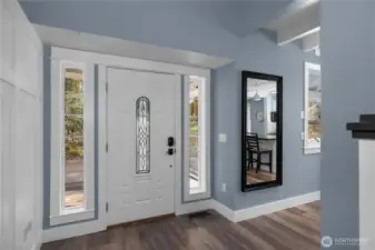 Bright entryway with tall ceilings and crisp finishes sets the tone inside.