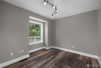 Bright main floor 2nd bedroom (near main floor full bath) provides flexibility for guests, office space, or everyday use.