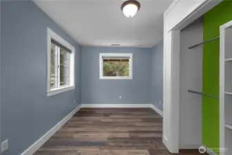 Bright 3rd bedroom includes LVP flooring closet storage and a comfortable layout.