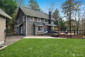 Great outdoor setup with usable yard space, entertaining deck, and additional outbuilding.