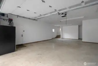 Large 5 car garage interior offers room for multiple vehicles and additional workspace. This is a 'de staged' photo... We cleaned up the photo by removing personal items.