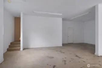 Spacious garage provides excellent utility for parking, projects, and everyday storage. This is a 'de staged' photo... We cleaned up the photo by removing personal items.