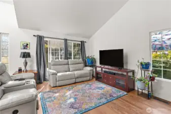 Enter to the corner living with vaulted ceilings.