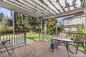 Back downstairs and off the Kitchen Dining is covered  deck and open patio.