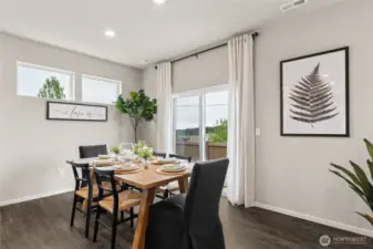 Convenient dining room next to the kitchen and island.  Photos are for representational purposes only.  Colors and finishes may vary.