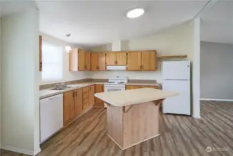 Looking into the kitchen form the dining area. Ample counter space and bar seating area.