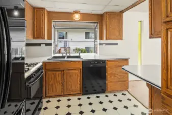 This fabulous kitchen shines with tons of counter space, great storage, and a gas stovetop.