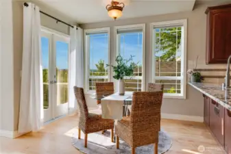 Seating area of the great room.  Eating bar is great for buffets on game day.  Deck access thru french doors with covered portion.