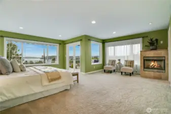 Amazing views in the primary suite!  Generous size easily fits king sized beds, seating &  fireplace for mood setting.  Private deck for a toast.  The escape from it all without leaving home.