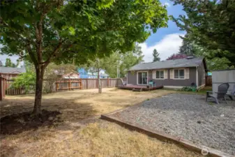 fully fenced backyard with swinging double gate