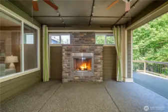 Outdoor living at its finest. Large, covered patio w/ stone fireplace, ceiling fans, string lights and a motorized screen make this space enjoyable year-round! You will love the super private vistas of the permanent greenbelt.