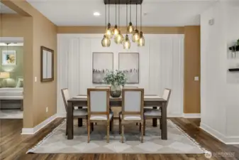 The stunning dining area offers custom wall treatments, a gorgeous chandelier and beautiful hard surface flooring.