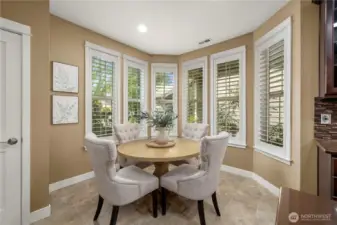 The cozy nook is bathed in natural light & offers gorgeous Plantation shutters.