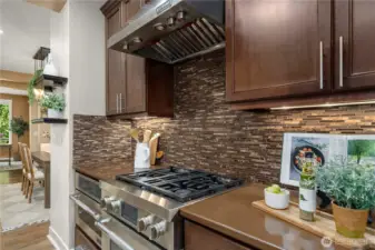 Top tier JennAir appliances and hood vent, stunning full height backsplash and classic cabinetry.