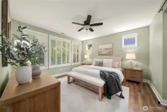 Generous primary bedroom with Plantation shutters overlooking the beautiful greenspace.