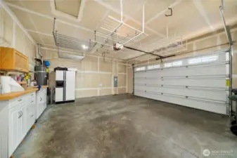 The Monaco's garage is wider than the typical 2 car garage in Trilogy. Bonus built-in workspace and the hanging storage!