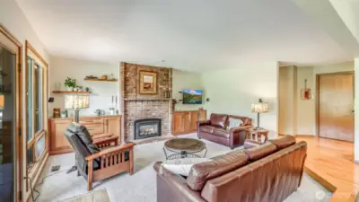 Relax in this cozy family room featuring a beautiful brick-surround gas fireplace.