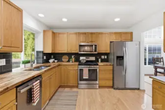This spacious kitchen features abundant cabinetry and easy maintenance flooring.