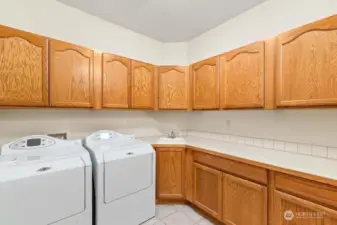 Awesome laundry room, washer and dryer stay with home! Tons of cabinetry, laundry sink and counter top space