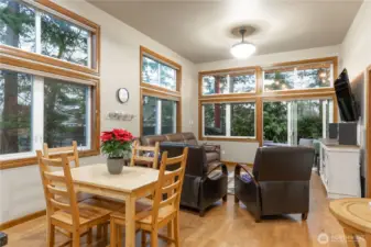 Dining room with living room in the background.over head light fixture has two settings, brightest shown here.