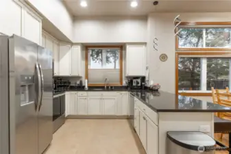 Note the white cabinetry and dark granite countertops.