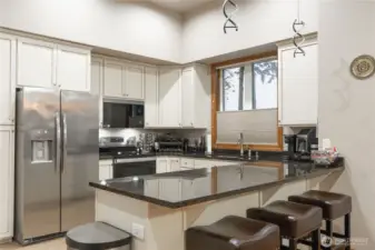 Eating bar could accommodate four barstools.  Creative lighting overhead is not turned on here.