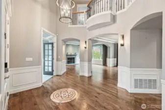 This grand entry welcomes you home with architectural touches and open hallway above.