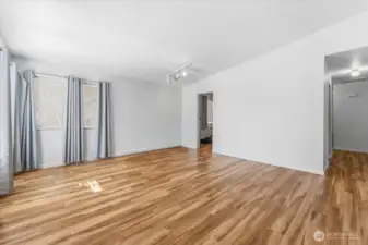 The units have been well updated and maintained over time. Step into the living room featuring vaulted ceilings and abundant natural light.