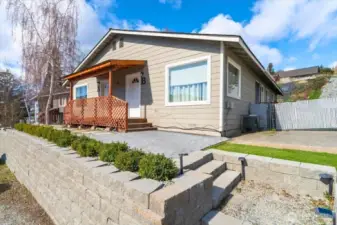 Recent improvements include a new retaining wall and thoughtfully designed low-maintenance landscaping.