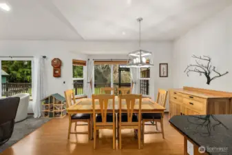 Dining space surrounded by multiple windows overlooking the property, offering a bright setting for everyday meals or entertaining.
