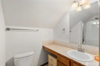 Bathroom on the upper level with a single-sink vanity and mirror, conveniently located near the upstairs bedroom and living space.