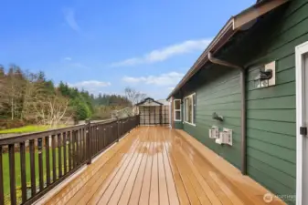 Extended deck area with railing and lighting, offering ample space for outdoor seating and entertaining.