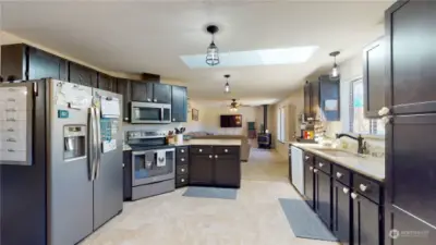 Kitchen leading into a family area with open layout.